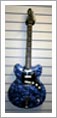 Blue_pearloid_semi_with_9_string_Vox_neck